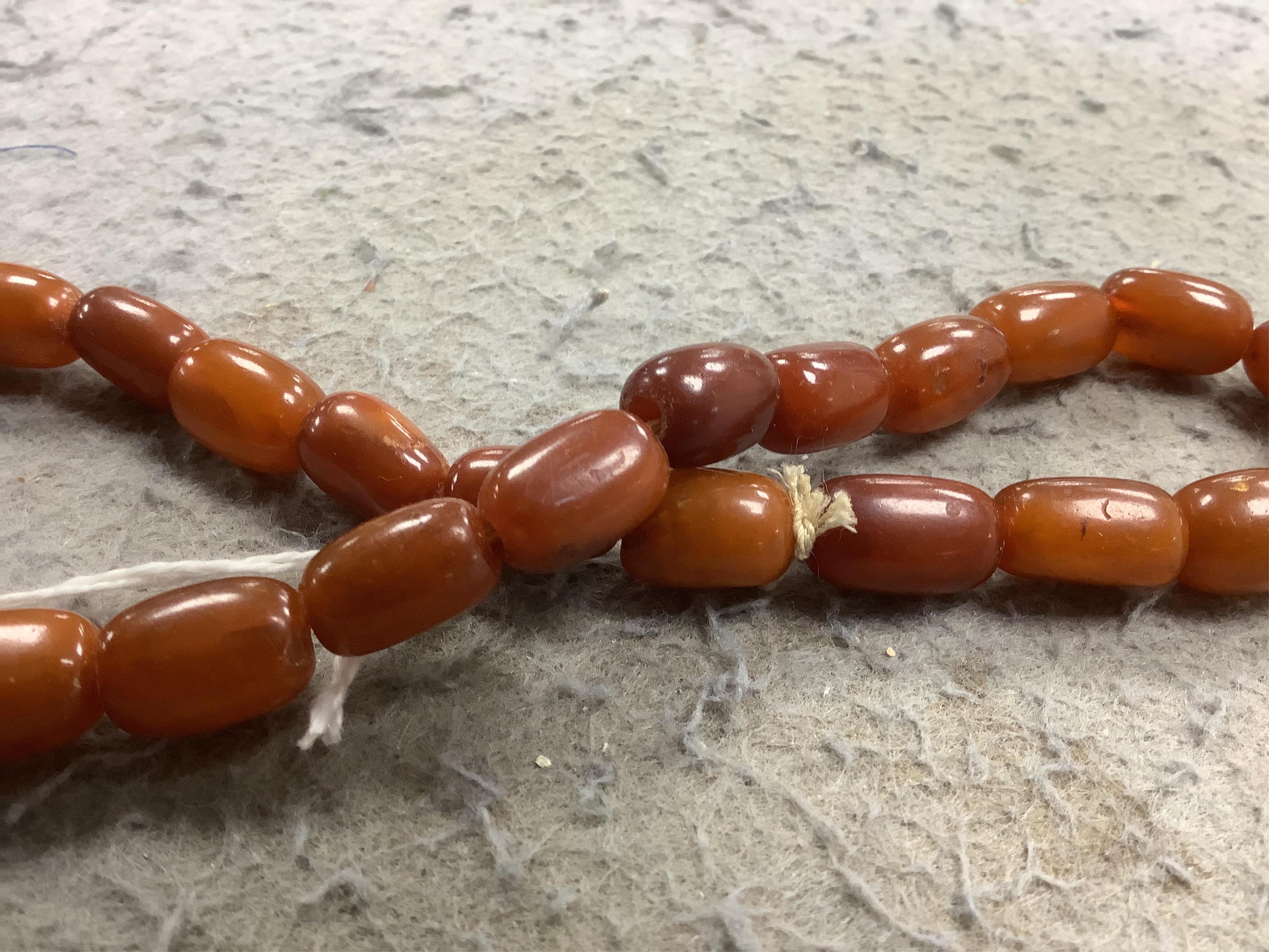 A single strand amber bead necklace, 34cm, gross weight 20 grams. Condition - poor to fair